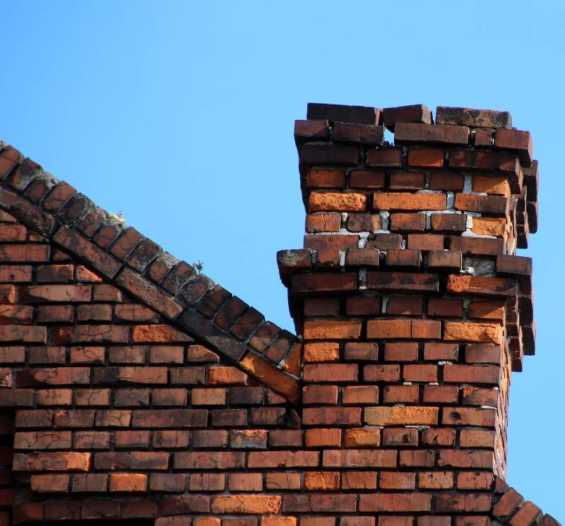 Signs Your Buffalo Grove Home Needs a Chimney Inspection Damaged chimney on an Buffalo Grove home showing cracks and missing mortar